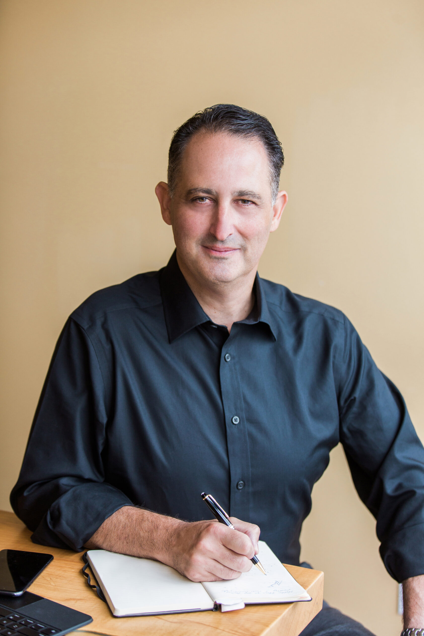 Joel Zimelstern seated with a notebook